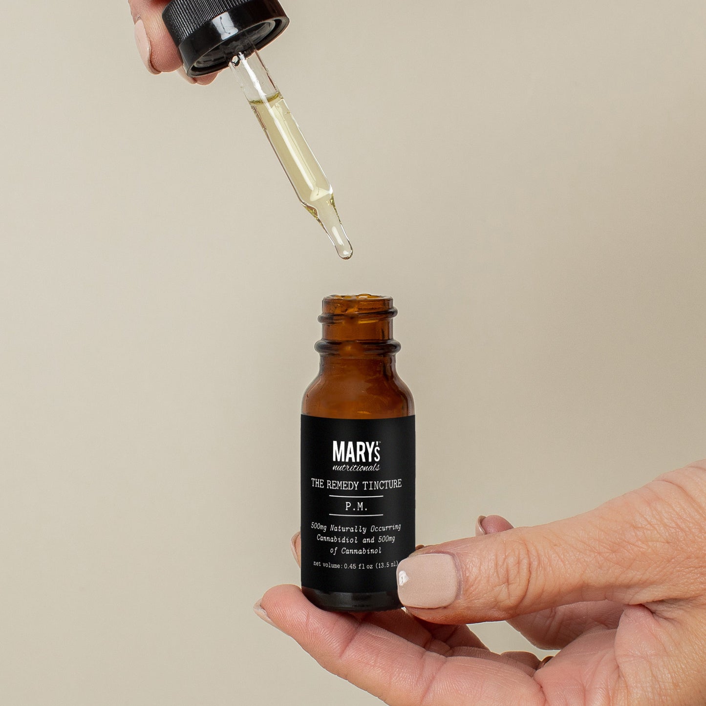 woman holding Mary's PM Remedy Tincture