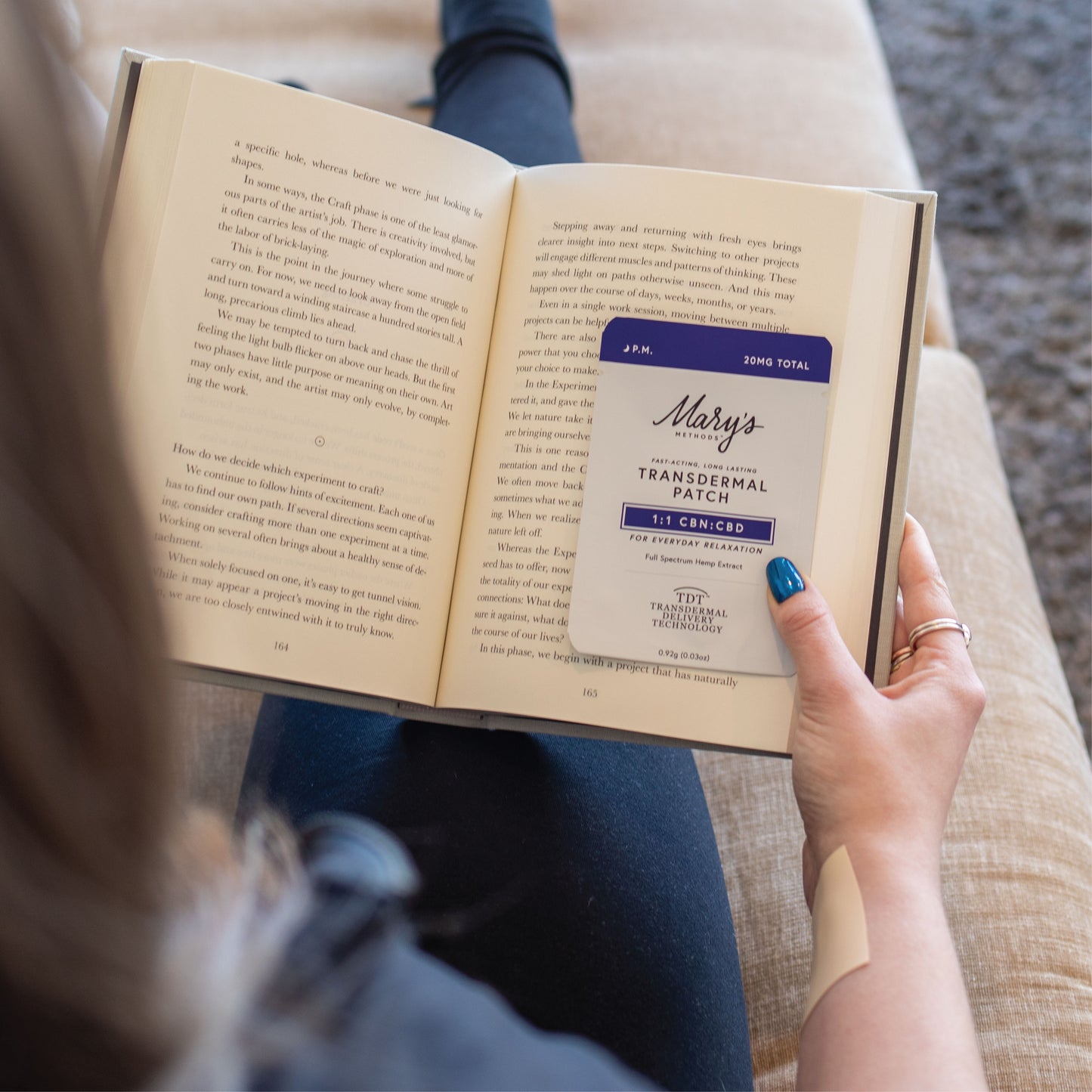 woman reading a book with P.M. Patch as her bookcover.