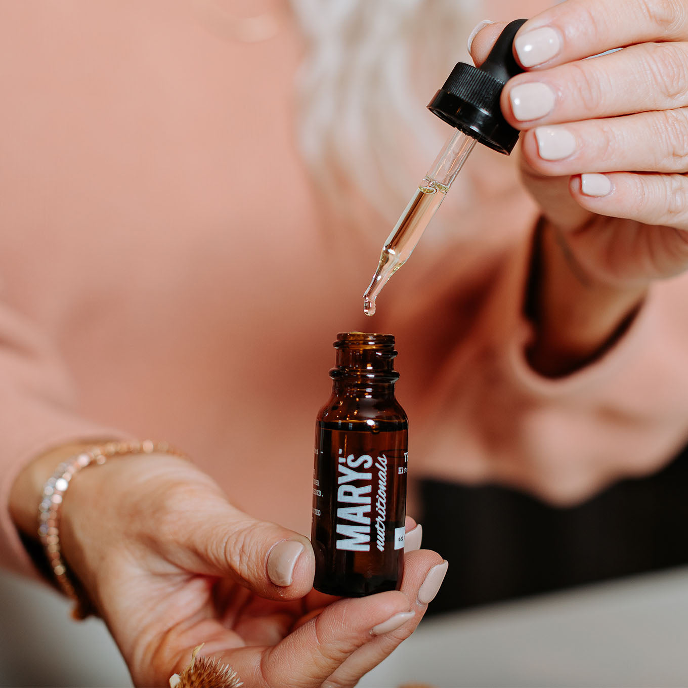 Woman getting a dropper of Mary's Nutritionals Remedy Tincture