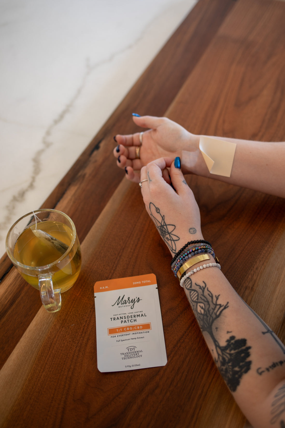 Hands with transdermal patch and tea