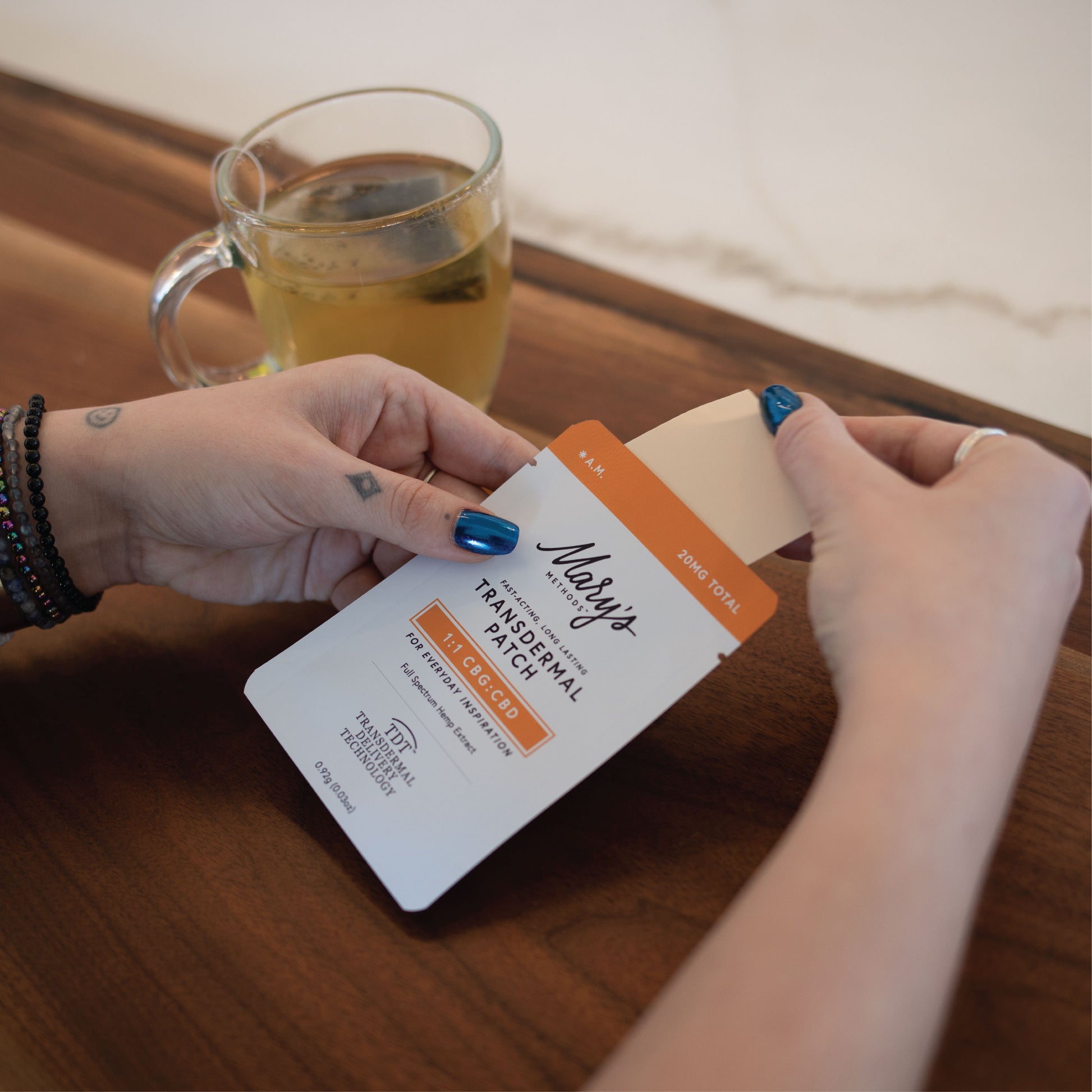 Woman drinking tea with A.M. Transdermal Patch