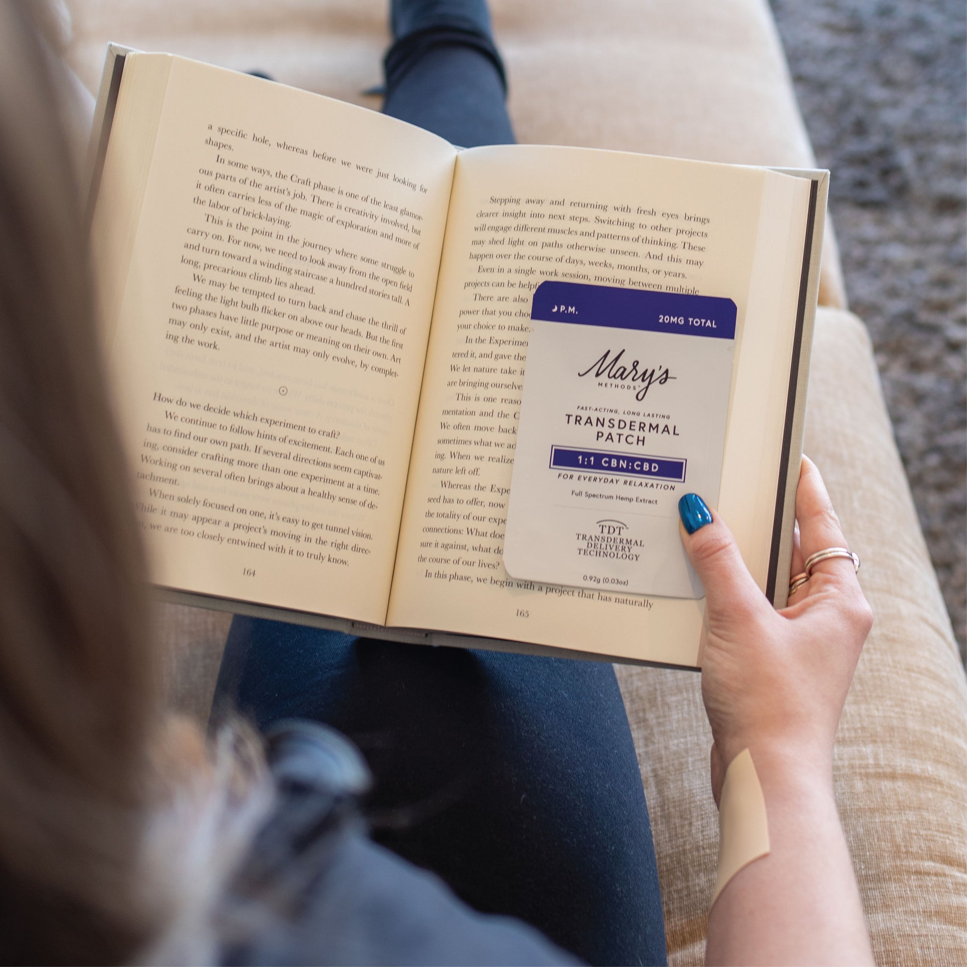 woman reading a book with P.M. Patch as her bookcover.