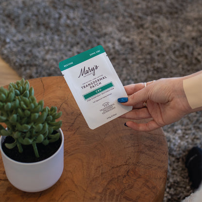 woman holding Restore CBD patch
